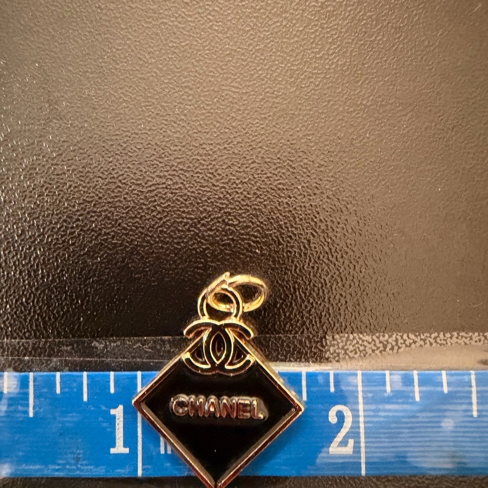 Authentic CHANEL Textured Black and Gold Square Pendant zipped pull